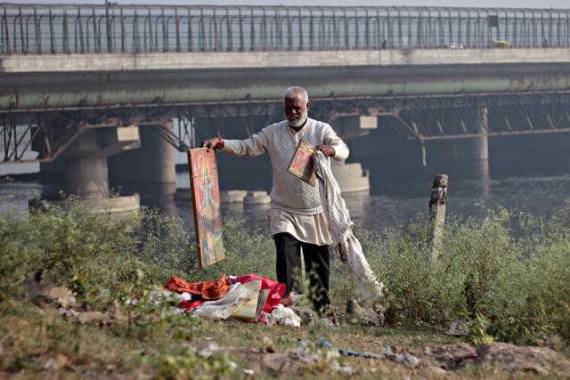Ashok Upadhyay, the man behind the drive, cleans the Chhath Ghat at the Yamuna River.