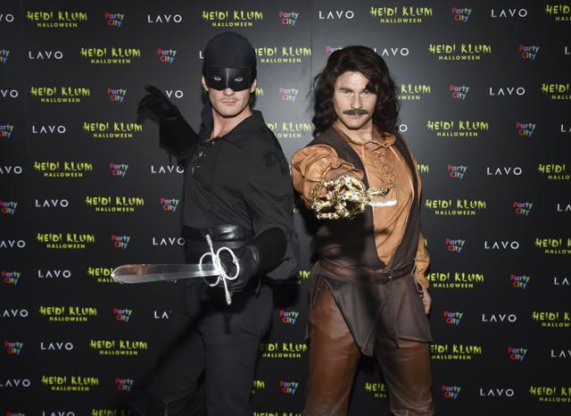 Actor Neil Patrick Harris, left, and husband David Burtka attend Heidi Klum's 19th annual Halloween party as Zorro and Inigo Montoya. (Evan Agostini/Invision/AP)