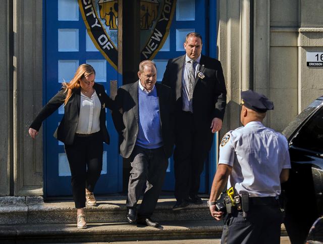 NYPD Detective Nicholas DiGaudio, right, escorts Harvey Weinstein, second left, to an unmarked vehicle while leaving the first precinct of the New York City Police Department after turning himself to authorities following allegations of sexual misconduct. (AP) NYPD Detective Nicholas DiGaudio, right, escorts Harvey Weinstein, second left, to an unmarked vehicle while leaving the first precinct of the New York City Police Department after turning himself to authorities following allegations of sexual misconduct. (AP)