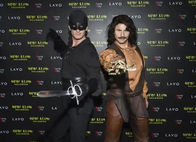 Actor Neil Patrick Harris, left, and husband David Burtka attend Heidi Klum’s 19th annual Halloween party as Zorro and Inigo Montoya. (AP)