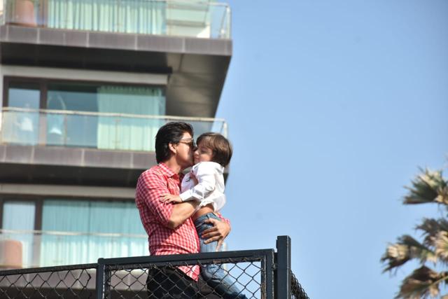 Shah Rukh Khan kisses AbRam as he greets his fans. (Viral Bhayani) Shah Rukh Khan kisses AbRam as he greets his fans. (Viral Bhayani)