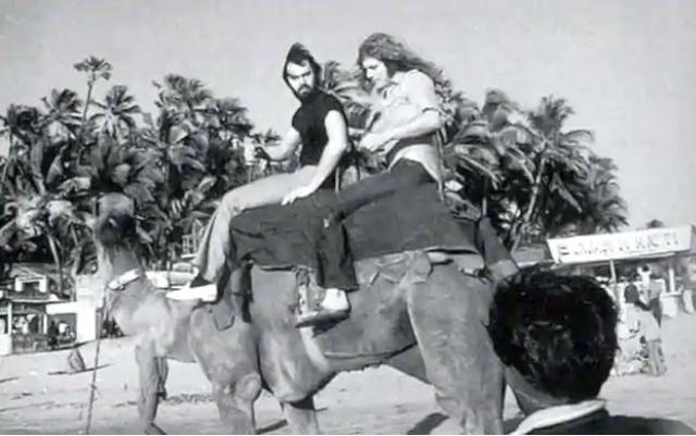 Led Zeppelin road manager Richard Cole and Robert Plant ride a camel at a Mumbai beach. (ledzeppelin.com)