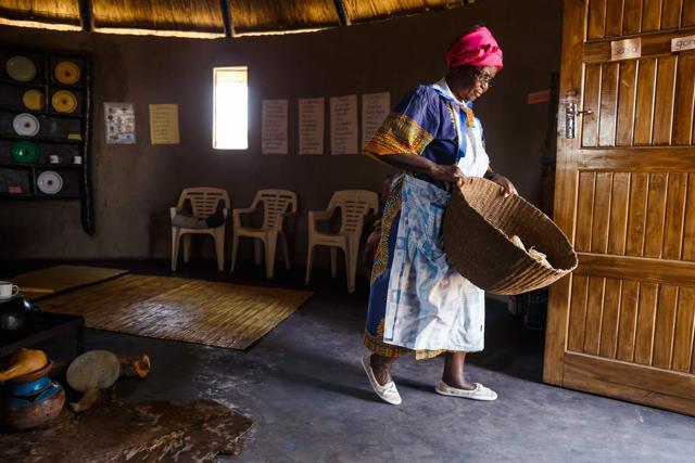 Hatifari Munongi carries a basket of corn. (AFP) Hatifari Munongi carries a basket of corn. (AFP)