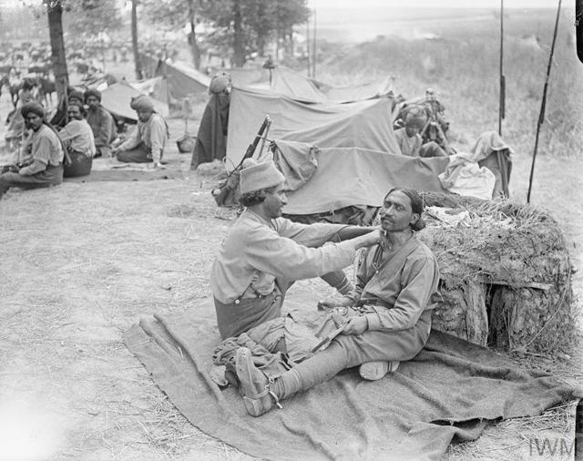 An Indian barber at work in the Indian Cavalry Camp, possibly the 9th Hodson’s Horse, near Querrieu, France, 29 July 1916. Several small makeshift tents can be seen in the background. This was during the 1916 Battle of the Somme. (Imperial War Museums) An Indian barber at work in the Indian Cavalry Camp, possibly the 9th Hodson’s Horse, near Querrieu, France, 29 July 1916. Several small makeshift tents can be seen in the background. This was during the 1916 Battle of the Somme. (Imperial War Museums)