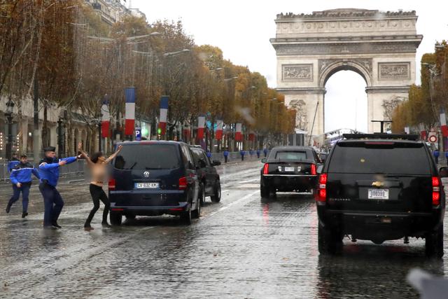 French police officers run after a topless protestor who ran toward the motorcade of President Donald Trump who was headed on the Champs Elysees to an Armistice Day Centennial Commemoration at the Arc de Triomphe, Sunday. (AP Photo) French police officers run after a topless protestor who ran toward the motorcade of President Donald Trump who was headed on the Champs Elysees to an Armistice Day Centennial Commemoration at the Arc de Triomphe, Sunday. (AP Photo)