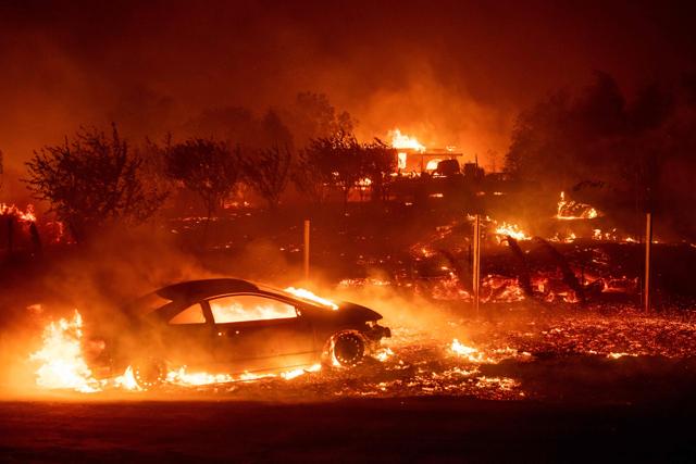 Vehicles and homes burn as the Camp fire tears through Paradise, California. More than 18,000 acres have been scorched in a matter of hours burning with it a hospital, a gas station and dozens of homes. ( (Josh Edelson /AFP)) Vehicles and homes burn as the Camp fire tears through Paradise, California. More than 18,000 acres have been scorched in a matter of hours burning with it a hospital, a gas station and dozens of homes. ( (Josh Edelson /AFP))