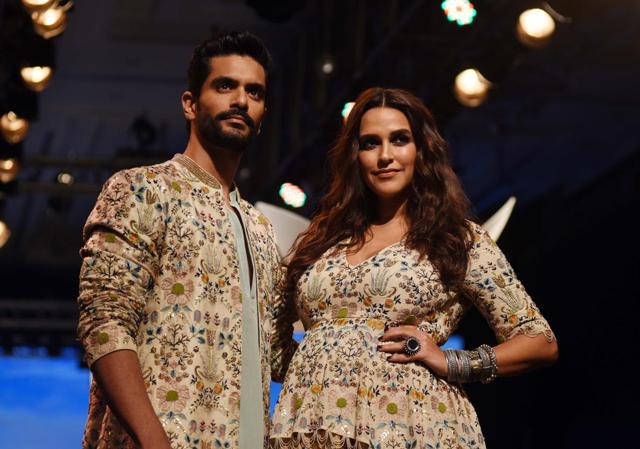 Neha Dhupia flaunted her baby bump as she walked the ramp at a fashion week with husband Angad Bedi . (AFP) Neha Dhupia flaunted her baby bump as she walked the ramp at a fashion week with husband Angad Bedi . (AFP)