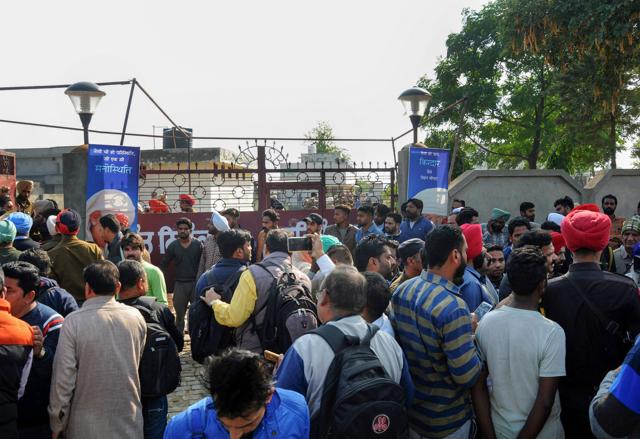 People gather at the Nirankari Bhawan, where two men on a motorcycle reportedly threw a grenade during a religious congregation, in Adliwal village near Amritsar, Punjab on Sunday. (PTI) People gather at the Nirankari Bhawan, where two men on a motorcycle reportedly threw a grenade during a religious congregation, in Adliwal village near Amritsar, Punjab on Sunday. (PTI)