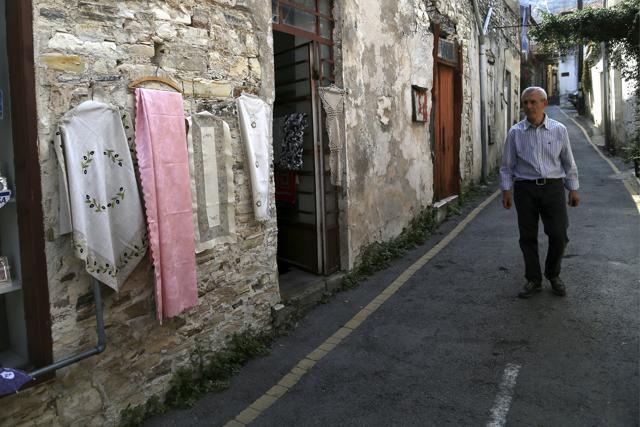 A man walks past shops selling the famous Lefkaritiko lace in Lefkara village, Cyprus. Legend has it that the intricate needlework used in embroidery known as ‘Lefkaritiko lace’ was of such high quality that Leonardo Da Vinci himself bought a tablecloth when he visited this mountainous village in the late 15th century and gifted it to Milan’s cathedral. (AP Photo/Petros Karadjias) A man walks past shops selling the famous Lefkaritiko lace in Lefkara village, Cyprus. Legend has it that the intricate needlework used in embroidery known as ‘Lefkaritiko lace’ was of such high quality that Leonardo Da Vinci himself bought a tablecloth when he visited this mountainous village in the late 15th century and gifted it to Milan’s cathedral. (AP Photo/Petros Karadjias)