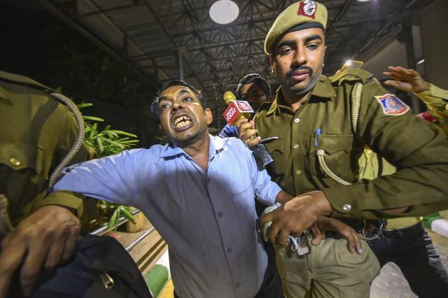 Police detain Anil Kumar, who allegedly threw chilli powder at Delhi Chief Minister Arvind Kejriwal, at Delhi Secretariat in New Delhi. (PTI Photo) Police detain Anil Kumar, who allegedly threw chilli powder at Delhi Chief Minister Arvind Kejriwal, at Delhi Secretariat in New Delhi. (PTI Photo)