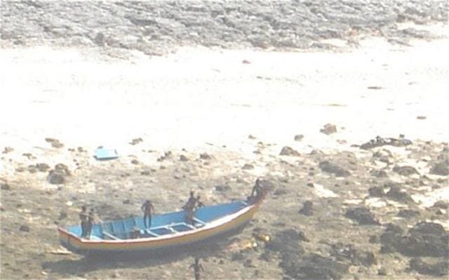 Men of the Sentinelese tribe capture the boat that drifted onto the shore. (Photo: Indian Coast Guard) Men of the Sentinelese tribe capture the boat that drifted onto the shore. (Photo: Indian Coast Guard)