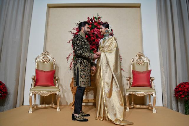 Ranveer Singh (L) and Deepika Padukone hold hands as they pose for photographers. (AFP) Ranveer Singh (L) and Deepika Padukone hold hands as they pose for photographers. (AFP)