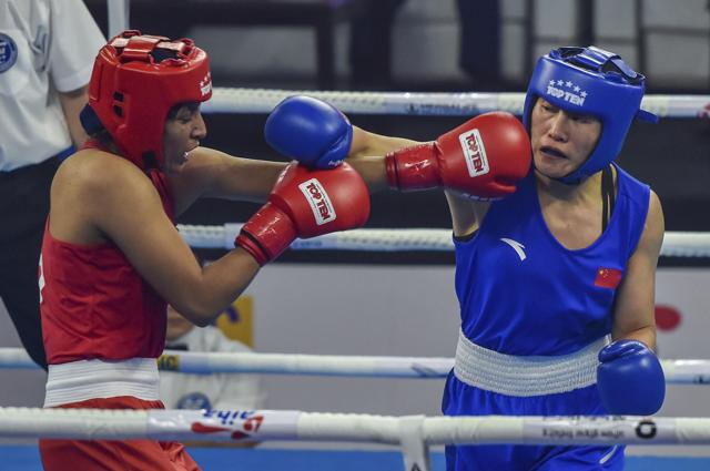 Simranjit Kaur (in Red) punches her Chinaese opponent Dan Dou during their semifinal match. (AP) Simranjit Kaur (in Red) punches her Chinaese opponent Dan Dou during their semifinal match. (AP)