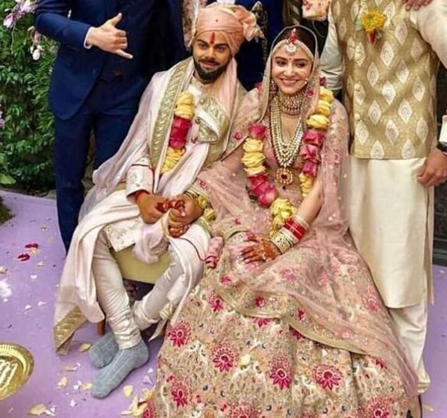 Virat Kohli and Anushka Sharma with friends and family at their wedding. Virat Kohli and Anushka Sharma with friends and family at their wedding.