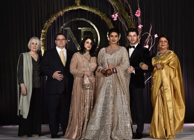 Priyanka Chopra and Nick Jonas pose for photos with their families. (PTI) Priyanka Chopra and Nick Jonas pose for photos with their families. (PTI)