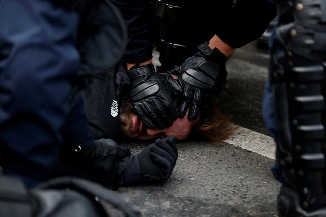 French CRS riot police apprehend a man in a street near Saint Lazare train station during a national day of protest by the yellow vests movement in Paris, France, December 8, 2018. (REUTERS) French CRS riot police apprehend a man in a street near Saint Lazare train station during a national day of protest by the yellow vests movement in Paris, France, December 8, 2018. (REUTERS)