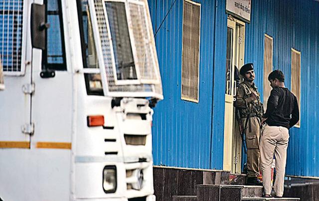 On Saturday evening, some RAF personnel cooked dinner next to portable toilets, a few others guarded about half-a-dozen trucks while most others rested on blankets spread over red mats inside the tin shed. (Sanchit Khanna/HT Photo) On Saturday evening, some RAF personnel cooked dinner next to portable toilets, a few others guarded about half-a-dozen trucks while most others rested on blankets spread over red mats inside the tin shed. (Sanchit Khanna/HT Photo)