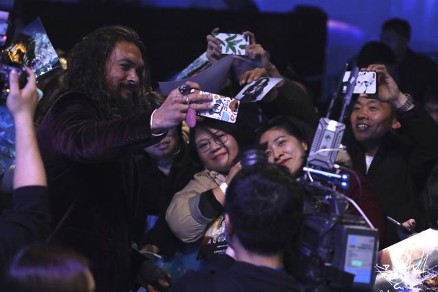 Actor Jason Momoa take selfies with fans during the red carpet event ahead of the Aquaman movie's world premiere in Beijing. (AP) Actor Jason Momoa take selfies with fans during the red carpet event ahead of the Aquaman movie's world premiere in Beijing. (AP)