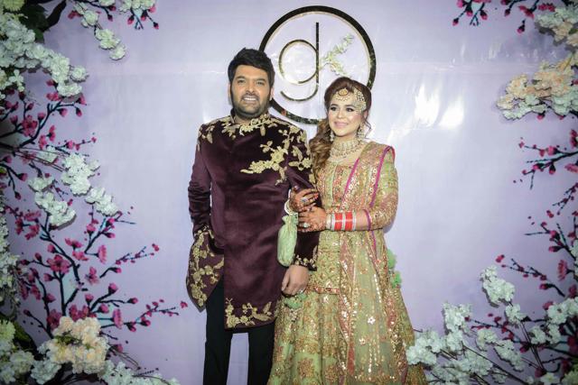 Kapil Sharma and his wife Ginni Chatrath pose during their wedding reception party at a hotel in Amritsar. (AFP)