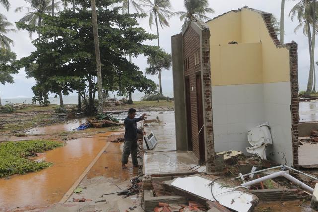 A resident looks for a usable item following a tsunami at a cottage in Tanjung Lesung, Indonesia on December 24. (AP Photo) A resident looks for a usable item following a tsunami at a cottage in Tanjung Lesung, Indonesia on December 24. (AP Photo)