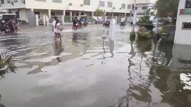 Pedestrians and vehicles move along a flooded street after a tropical depression descended upon Daet, Camarines Norte, the Philippines. (REUTERS) Pedestrians and vehicles move along a flooded street after a tropical depression descended upon Daet, Camarines Norte, the Philippines. (REUTERS)