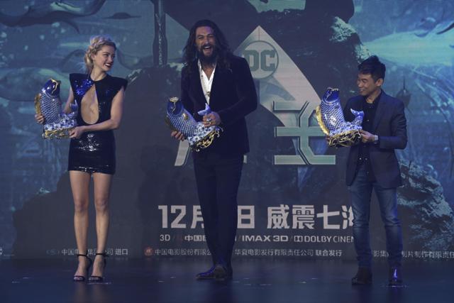 Aquaman actors Jason Momoa, centre, Amber Heard and director James Wan pose for a photo during an event in Beijing, China. (AP)