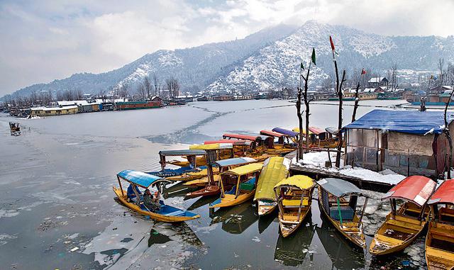 A Kashmiri boatman rows his Shikara, a traditional wooden boat, as others are seen parked after a spell of fresh snowfall in Srinagar, Indian controlled Kashmir, Saturday, Jan. 5, 2019. The Kashmir region has been experiencing snow for few days resulting in disruption of air traffic and road traffic between Srinagar and Jammu, the summer and winter capitals of India's troubled state. (AP) A Kashmiri boatman rows his Shikara, a traditional wooden boat, as others are seen parked after a spell of fresh snowfall in Srinagar, Indian controlled Kashmir, Saturday, Jan. 5, 2019. The Kashmir region has been experiencing snow for few days resulting in disruption of air traffic and road traffic between Srinagar and Jammu, the summer and winter capitals of India's troubled state. (AP)