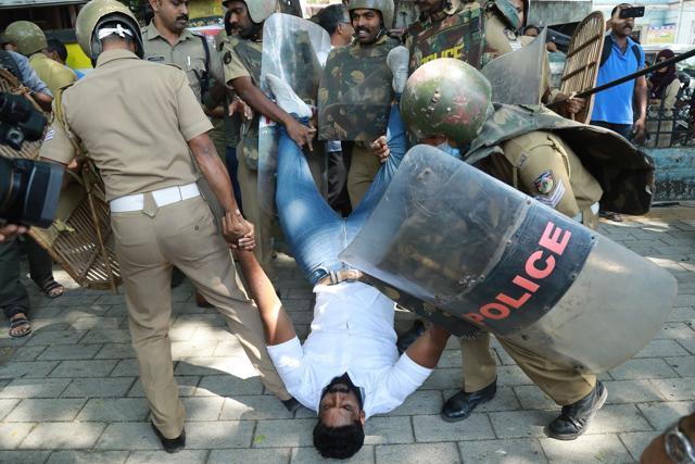Police detain an activist amid demonstrations after women entered the Sabarimala temple, in Kochi in Kerala. (AFP) Police detain an activist amid demonstrations after women entered the Sabarimala temple, in Kochi in Kerala. (AFP)