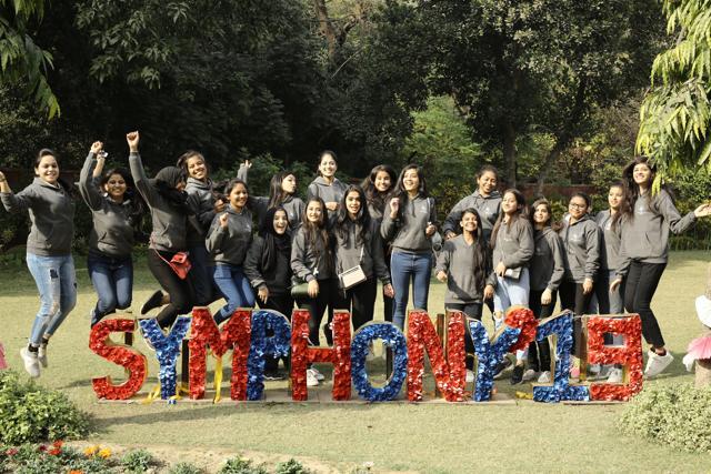 Janki Devi Memorial College’s Cultuyral Team poses next to a fest signage at Symphony ’19 (Manoj Verma/HT)