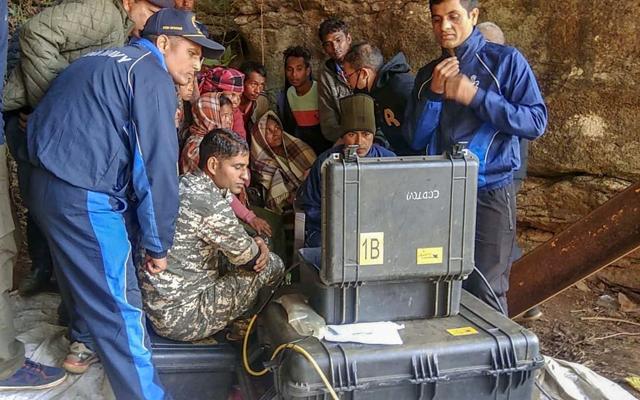 Naval divers look at the captured pictures of one of the 15 miners trapped in illegal rat mines since Dec. 13, in Ksan area of East Jaintia Hills. (PTI) Naval divers look at the captured pictures of one of the 15 miners trapped in illegal rat mines since Dec. 13, in Ksan area of East Jaintia Hills. (PTI)