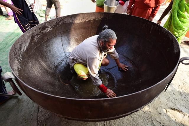 A man cleans huge Kadahi (pan) to be used for cooking food for pilgrims at a camp during the ongoing Kumbh Mela 2019 festival in Allahabad. (PTI Photo) A man cleans huge Kadahi (pan) to be used for cooking food for pilgrims at a camp during the ongoing Kumbh Mela 2019 festival in Allahabad. (PTI Photo)