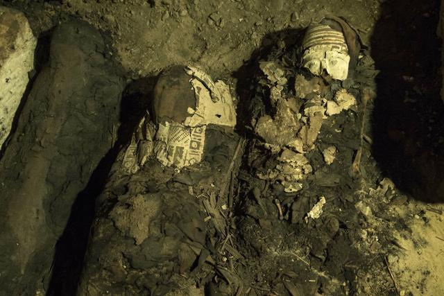 Mummy cases lie in a recently discovered burial chamber in the desert province of Minya, south of Cairo, Egypt. (AP)