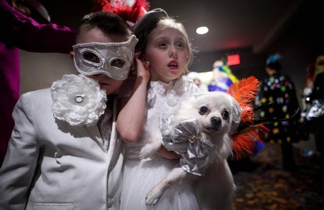 Two children hold their dog, dressed up for a show, backstage at the 16th annual New York Pet Fashion Show on February 7, 2019 in New York City. (Photo by Johannes EISELE / AFP) (AFP) Two children hold their dog, dressed up for a show, backstage at the 16th annual New York Pet Fashion Show on February 7, 2019 in New York City. (Photo by Johannes EISELE / AFP) (AFP)