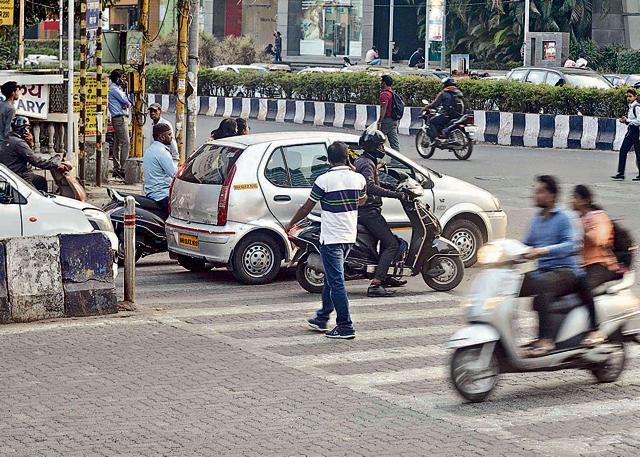Pedestrians face inconvience while crossing the road at a zebra crossing at the Senapati Bapat road chowk. (Ravindra Joshi/HT PHOTO)