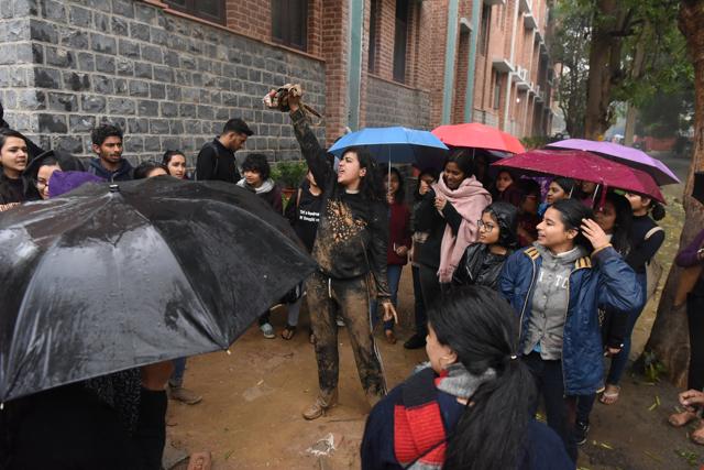 The protesting group celebrates with shreds of the poster. (Sarang Gupta/HT Photo)