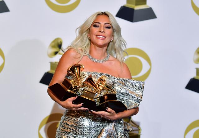 Singer/songwriter Lady Gaga poses with her awards at the Grammys. (AFP)