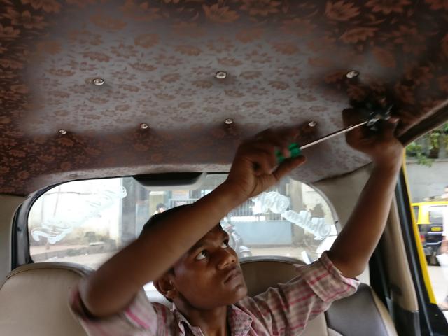 Akbar’s assistants Mohammad Maqsood and Mohammad Shajaad (in pic) fit about 4 to 5 cars on a good day. “You need a gentle hand and strength for this job,” Shajaad says. (Rachel Lopez) Akbar’s assistants Mohammad Maqsood and Mohammad Shajaad (in pic) fit about 4 to 5 cars on a good day. “You need a gentle hand and strength for this job,” Shajaad says. (Rachel Lopez)