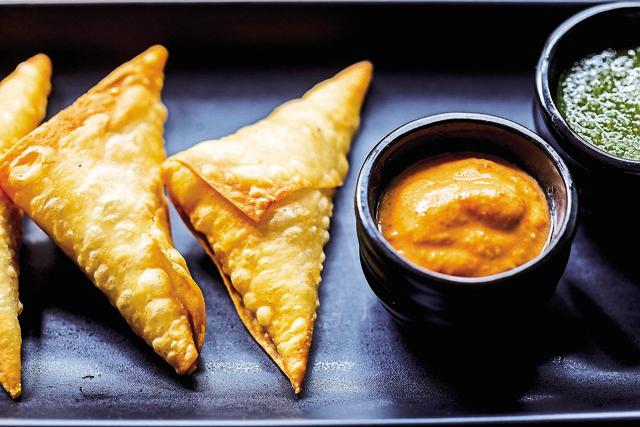 Chicken samosas served with spicy sesame and red chillies chutney, and tamarind chutney (Ming Tang-Evans) Chicken samosas served with spicy sesame and red chillies chutney, and tamarind chutney (Ming Tang-Evans)