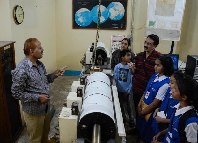Staff member of India Meteorological Department explains how this machine measures earthquakes. (Milind Saurkar/HT Photo)