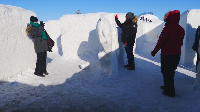 People take pictures near a statue carved out of snow within the world's largest snow. (AFP) People take pictures near a statue carved out of snow within the world's largest snow. (AFP)
