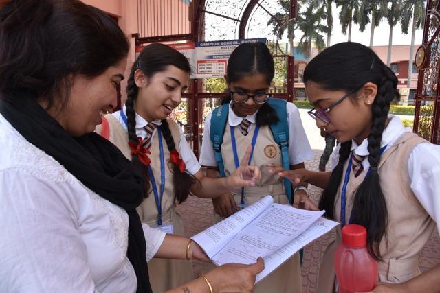 A curious mother taking note of science paper with students of CBSE Class 10 coming out of Campion school after writing science paper in Bhopal on Wednesday. (Mujeeb Faruqui/HT Photo) A curious mother taking note of science paper with students of CBSE Class 10 coming out of Campion school after writing science paper in Bhopal on Wednesday. (Mujeeb Faruqui/HT Photo)