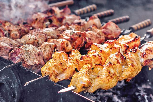 A kebab cooked over a skewer on the streets of Lucknow (Shutterstock)
