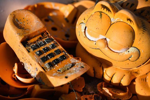 Spare parts of plastic 'Garfield' phones are displayed on the beach. (AFP) Spare parts of plastic 'Garfield' phones are displayed on the beach. (AFP)