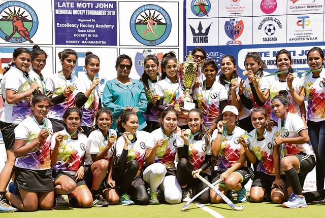 Excellency Academy with their trophy after winning their maiden Moti John invitational hockey tournament title at Major Dhyan Chand hockey poligras stadium on Sunday. (HT/PHOTO)