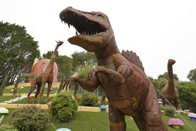 Dinosaurs and other figurines stand in the backyard of the Flintstone House. (AP) Dinosaurs and other figurines stand in the backyard of the Flintstone House. (AP)