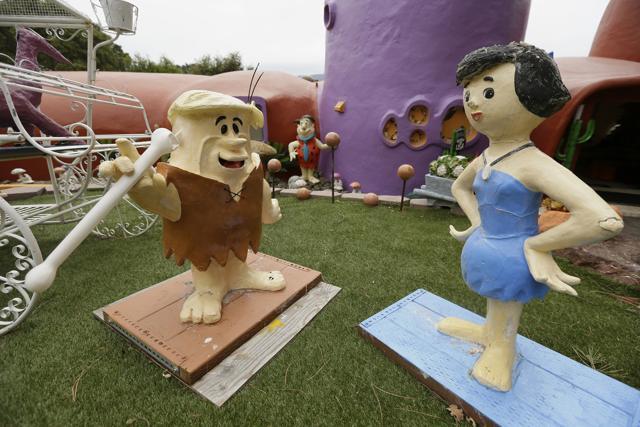 Figurines of Barney and Betty Rubble stand outside the Flintstone House. (AP) Figurines of Barney and Betty Rubble stand outside the Flintstone House. (AP)
