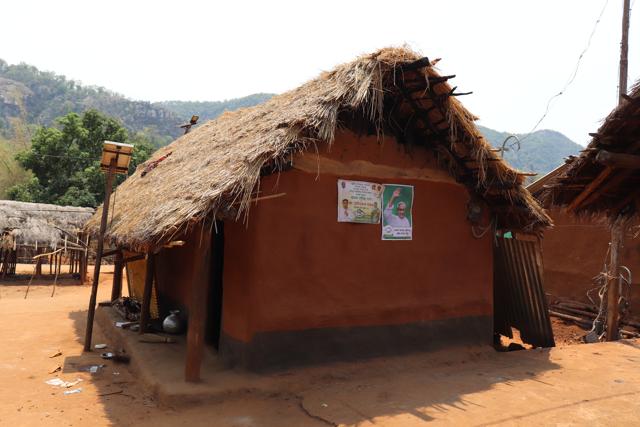 Posters of political party pasted on the house of a Juanga tribal in Nagada. (Biswajit Mohanty/HT Photo)