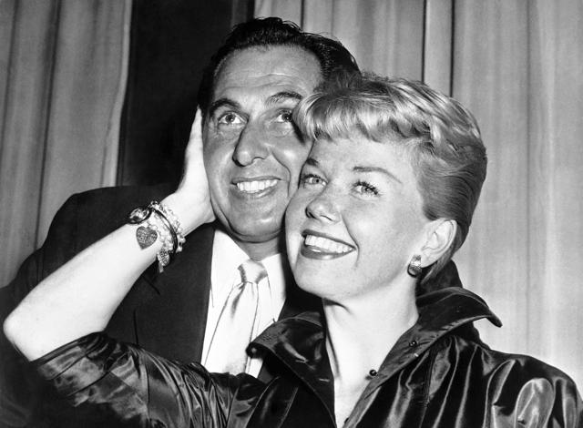 In this April 12, 1955 file photo, film actress and singer Doris Day poses with her husband and agent Martin Melcher at their hotel after arriving in London. (AP) In this April 12, 1955 file photo, film actress and singer Doris Day poses with her husband and agent Martin Melcher at their hotel after arriving in London. (AP)