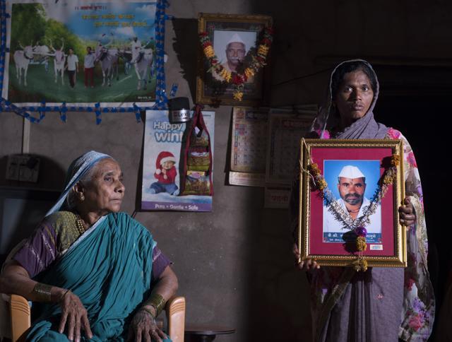 Gangubai Bhanuse(L) looks on as Rekha Bhanuse (R) poses with a picture of her husband Sanjay Bhanuse who died in crocodile attack in Tung village, Sangli. (Anshuman Poyrekar/HT Photo) Gangubai Bhanuse(L) looks on as Rekha Bhanuse (R) poses with a picture of her husband Sanjay Bhanuse who died in crocodile attack in Tung village, Sangli. (Anshuman Poyrekar/HT Photo)