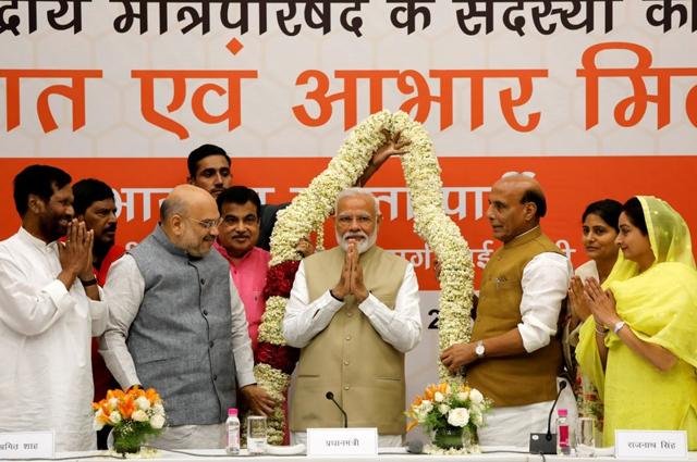 Prime Minister Narendra Modi gestures as he is presented with a garland during a thanksgiving ceremony by Bharatiya Janata Party (BJP) leaders to its allies at the party headquarters in New Delhi, India, May 21, 2019. (REUTERS) Prime Minister Narendra Modi gestures as he is presented with a garland during a thanksgiving ceremony by Bharatiya Janata Party (BJP) leaders to its allies at the party headquarters in New Delhi, India, May 21, 2019. (REUTERS)